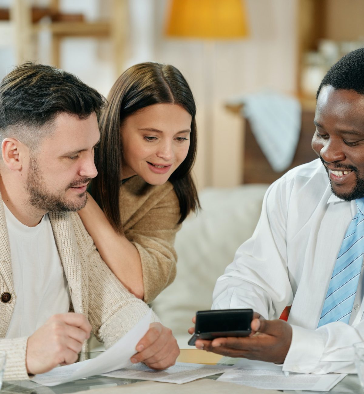 content-man-advising-young-couple-on-home-loan.jpg